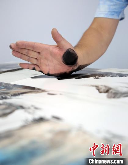 颉俊峰在创作指掌画。　陈月振 摄